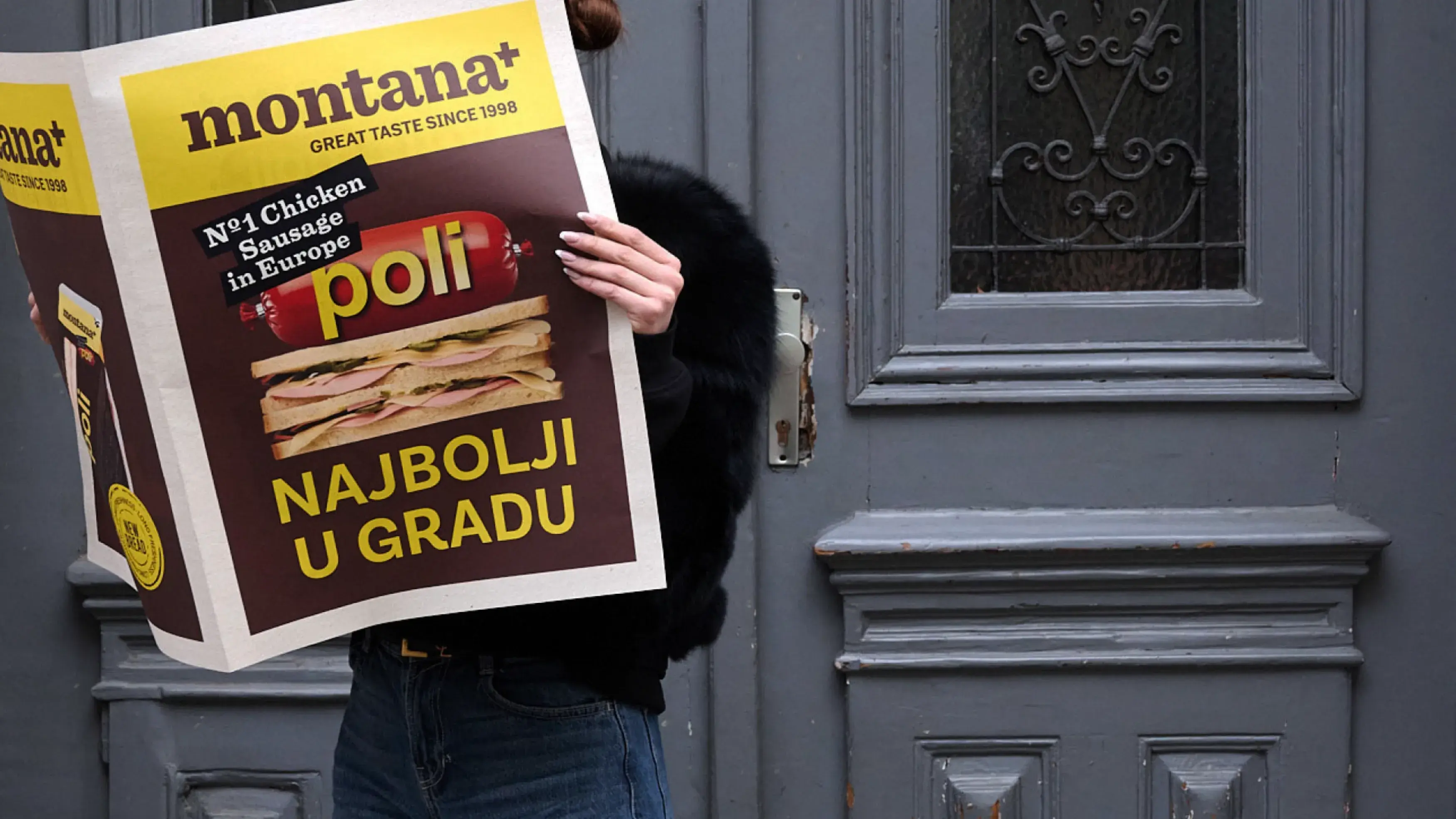 Djevojka drži novine sa sendvičem na naslovnici